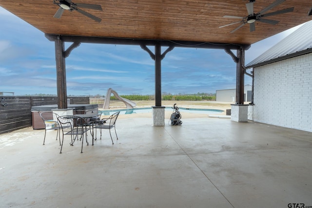 view of patio / terrace featuring ceiling fan and a fenced in pool