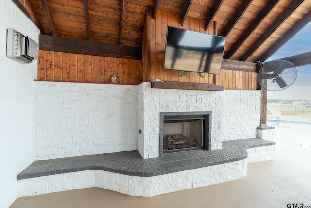 room details with a wall mounted AC, beamed ceiling, a stone fireplace, and wood ceiling