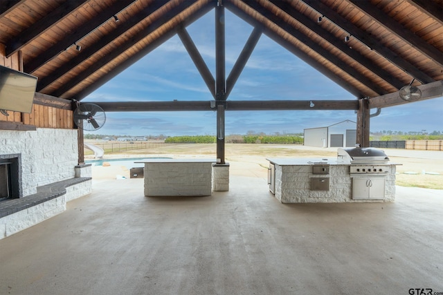 view of patio featuring a fenced in pool, a grill, and an outdoor kitchen