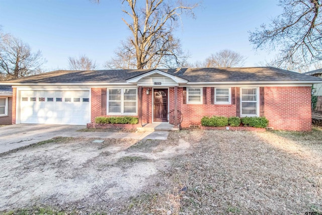 single story home with brick siding, an attached garage, and driveway