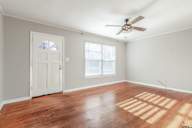 foyer with baseboards, wood finished floors, and crown molding