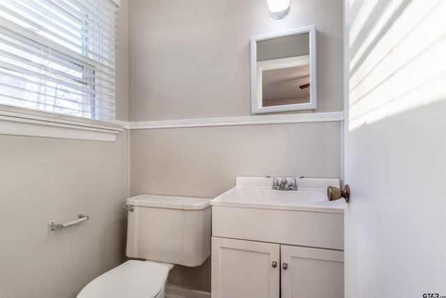 bathroom with toilet, tile walls, and vanity