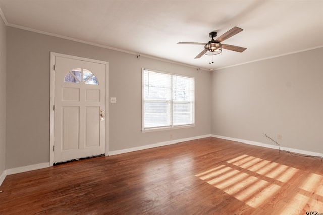 foyer with crown molding, baseboards, and wood finished floors