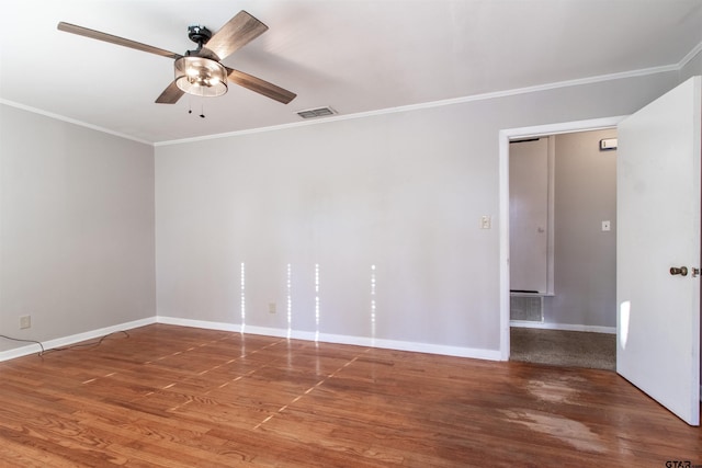 unfurnished room featuring baseboards, visible vents, a ceiling fan, wood finished floors, and crown molding