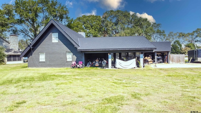 rear view of property featuring a yard