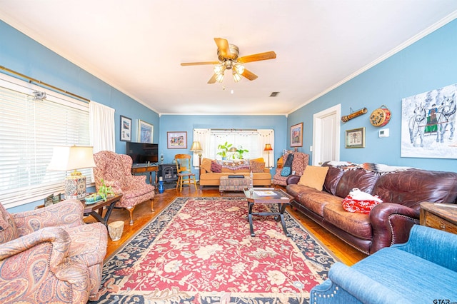 living room with wood-type flooring, ceiling fan, and crown molding