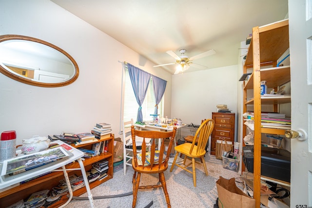 carpeted dining area with ceiling fan