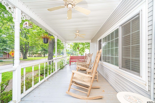 wooden deck with covered porch and ceiling fan