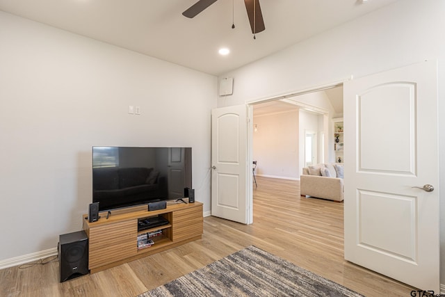 living room featuring ceiling fan and wood-type flooring