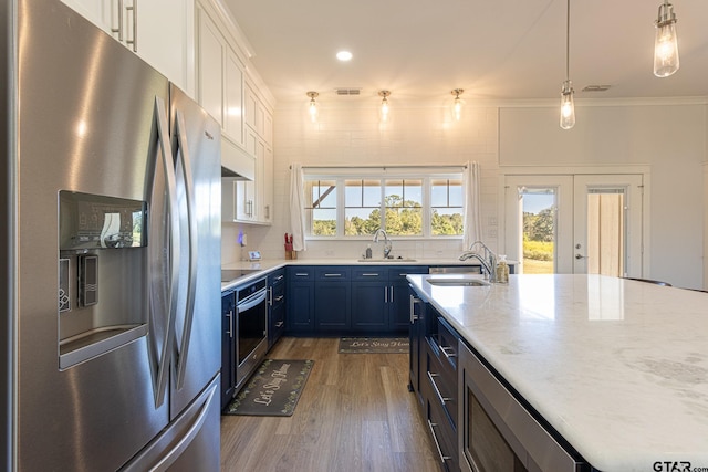 kitchen featuring stainless steel appliances, blue cabinets, dark wood-type flooring, sink, and white cabinets