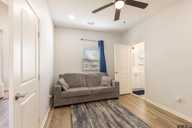 living room featuring ceiling fan and hardwood / wood-style flooring