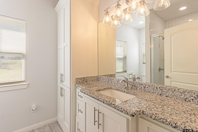 bathroom featuring vanity, hardwood / wood-style flooring, and walk in shower