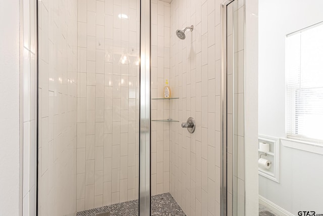 bathroom with a shower with door