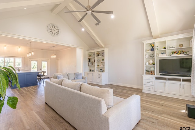 living room featuring beamed ceiling, light hardwood / wood-style flooring, high vaulted ceiling, and ceiling fan with notable chandelier