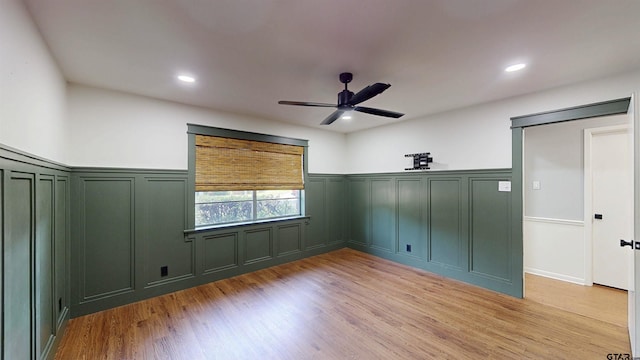 2505 Merry Ln, Tyler, TX 75701 - unfurnished bedroom featuring a decorative wall, light wood-type flooring, a wainscoted wall, recessed lighting, and a ceiling fan