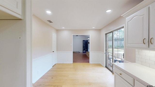 2505 Merry Ln, Tyler, TX 75701 - hallway with light wood-style flooring, wainscoting, and recessed lighting