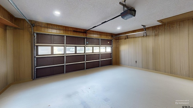 2505 Merry Ln, Tyler, TX 75701 - garage with a garage door opener, wood walls, and recessed lighting