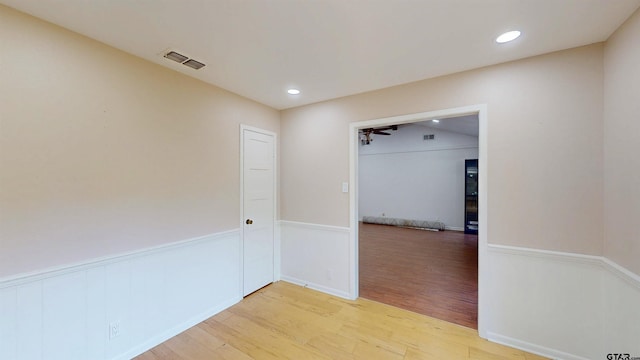 2505 Merry Ln, Tyler, TX 75701 - unfurnished room featuring light wood finished floors, wainscoting, and recessed lighting