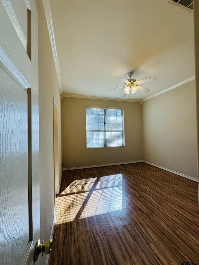 spare room with ceiling fan, ornamental molding, and dark hardwood / wood-style flooring