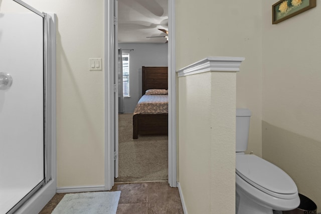 bathroom with walk in shower, ceiling fan, and toilet