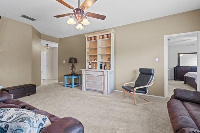 living room featuring light carpet and ceiling fan