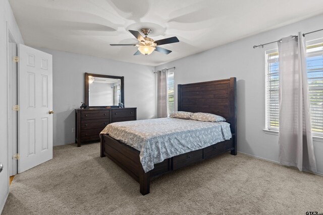 bedroom with light carpet and ceiling fan