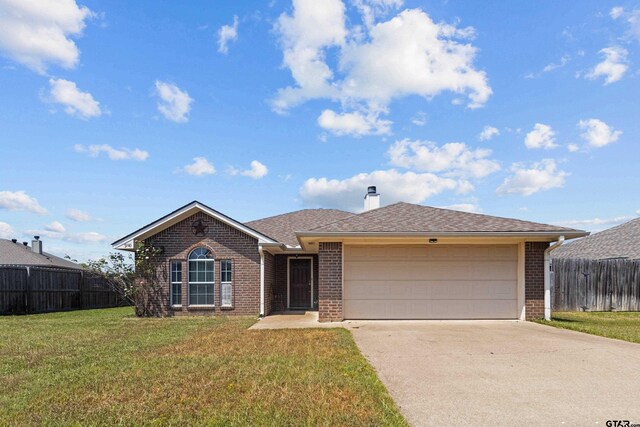 ranch-style house featuring a garage and a front lawn