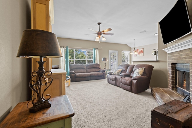 carpeted living room with a fireplace and ceiling fan