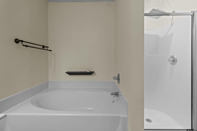 bathroom featuring shower with separate bathtub