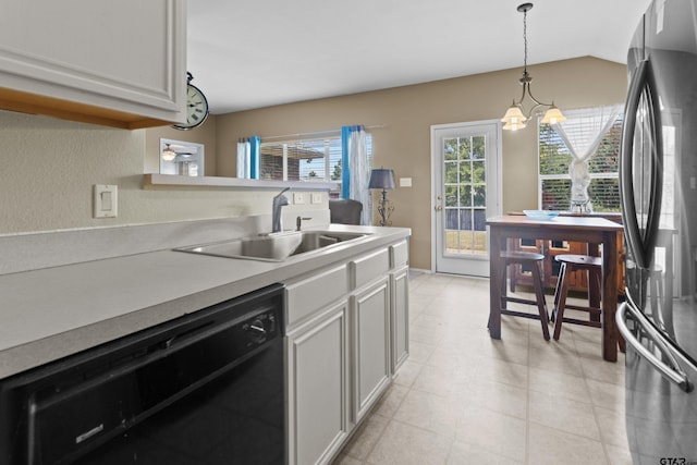 kitchen featuring black dishwasher, hanging light fixtures, sink, a chandelier, and stainless steel fridge