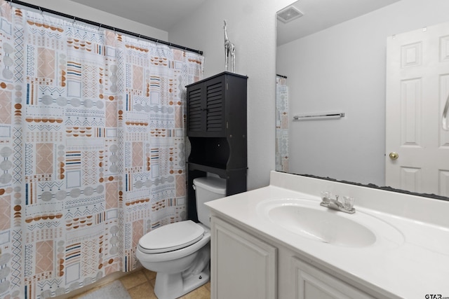 bathroom featuring toilet, vanity, a shower with shower curtain, and tile patterned flooring