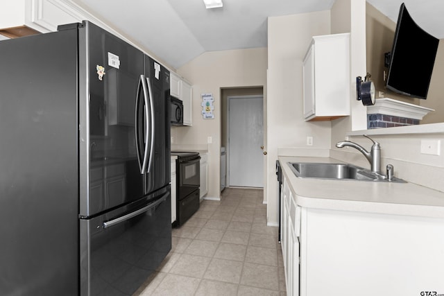 kitchen with black appliances, white cabinetry, sink, and vaulted ceiling