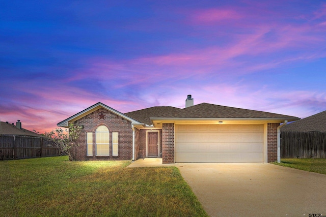 single story home with a garage and a lawn