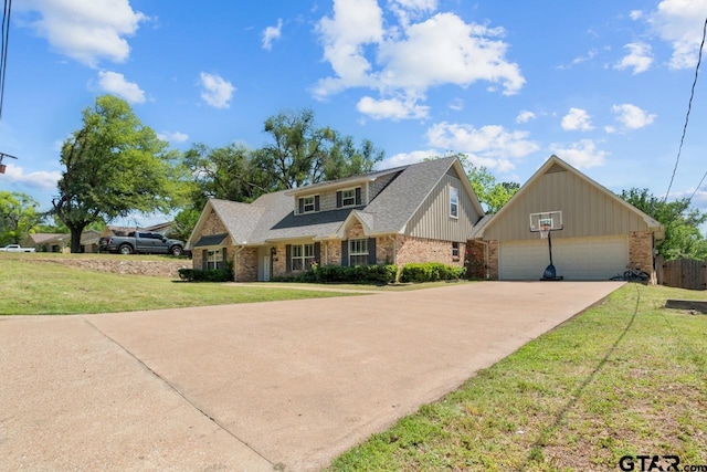 craftsman-style home featuring driveway, roof with shingles, a front yard, and an outbuilding