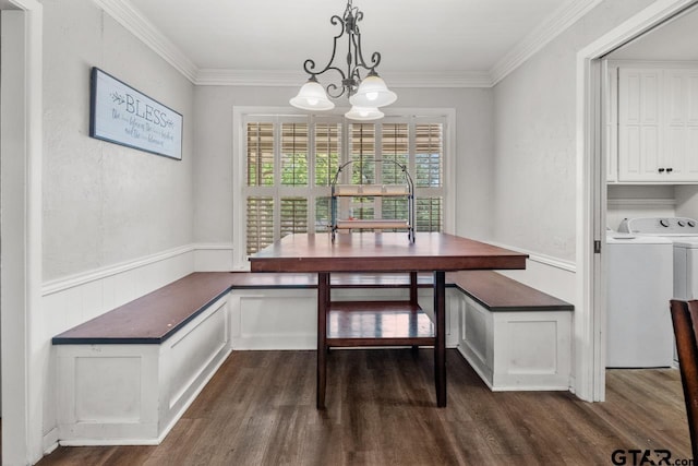 dining space with ornamental molding, an inviting chandelier, dark wood-style flooring, and a wainscoted wall