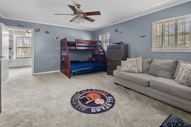 carpeted bedroom with a ceiling fan, baseboards, crown molding, and multiple windows