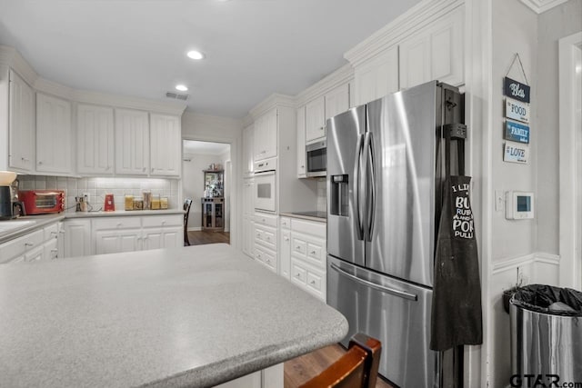 kitchen featuring white cabinetry, appliances with stainless steel finishes, visible vents, and recessed lighting