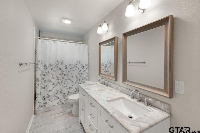 bathroom with toilet, a sink, double vanity, and curtained shower