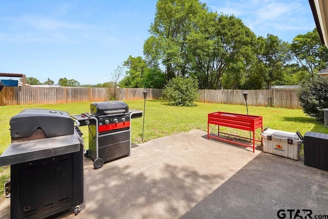 view of patio / terrace with a fenced backyard and a grill