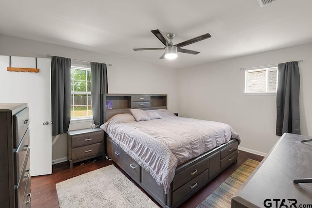 bedroom featuring baseboards, dark wood-style floors, and ceiling fan