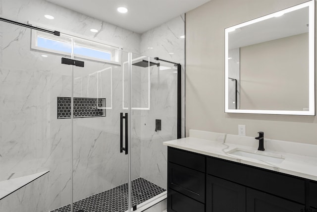 bathroom with vanity and a shower with shower door