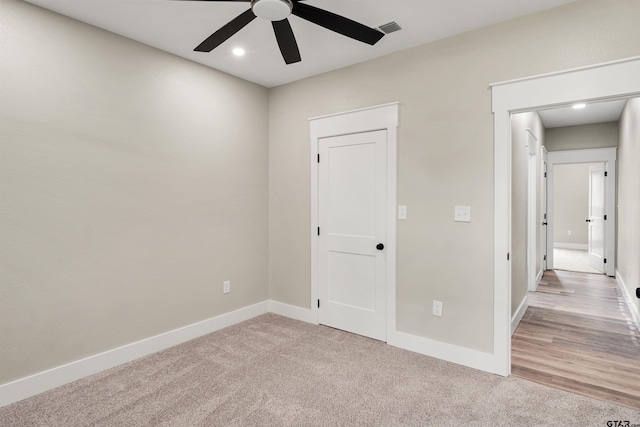 carpeted empty room featuring ceiling fan