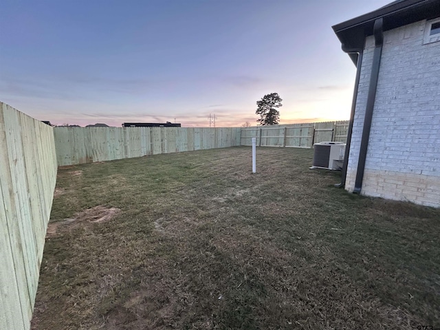 yard at dusk featuring cooling unit