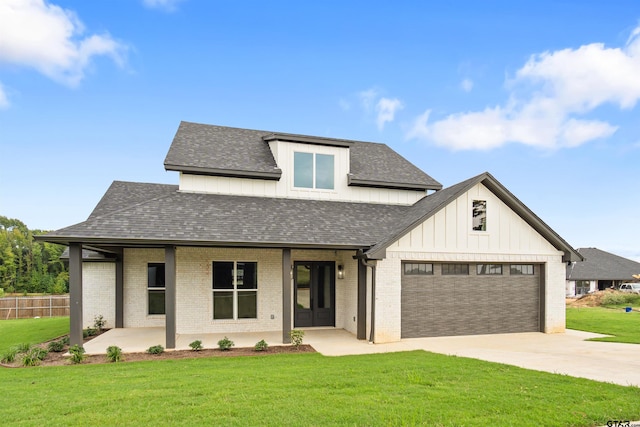 modern inspired farmhouse featuring a garage and a front lawn