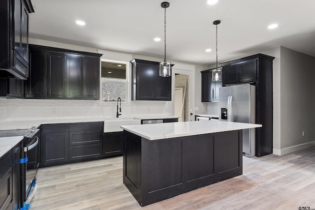 kitchen featuring a kitchen island, sink, pendant lighting, and range with electric stovetop