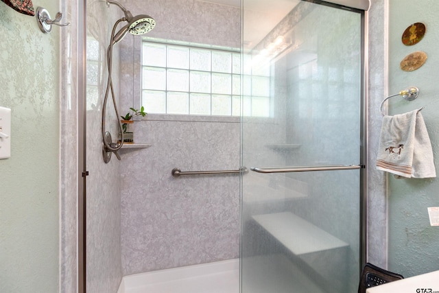 bathroom featuring a shower with door