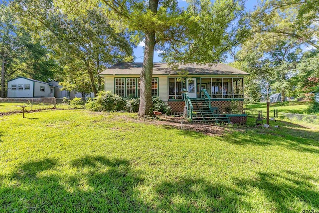 rear view of house featuring a lawn