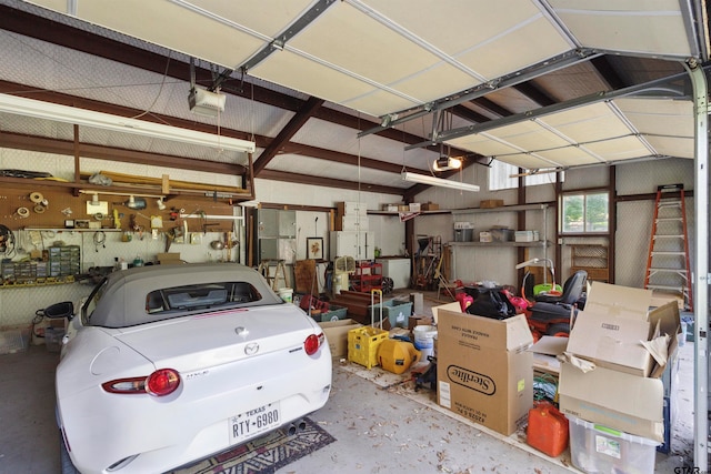 garage featuring a garage door opener and a workshop area