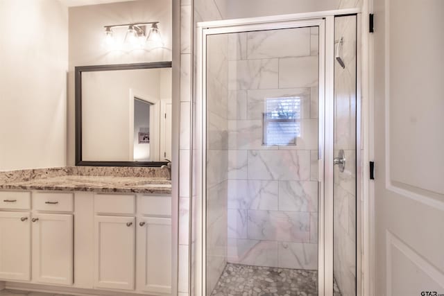 bathroom with walk in shower and vanity