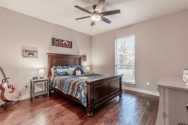 bedroom with dark hardwood / wood-style flooring and ceiling fan